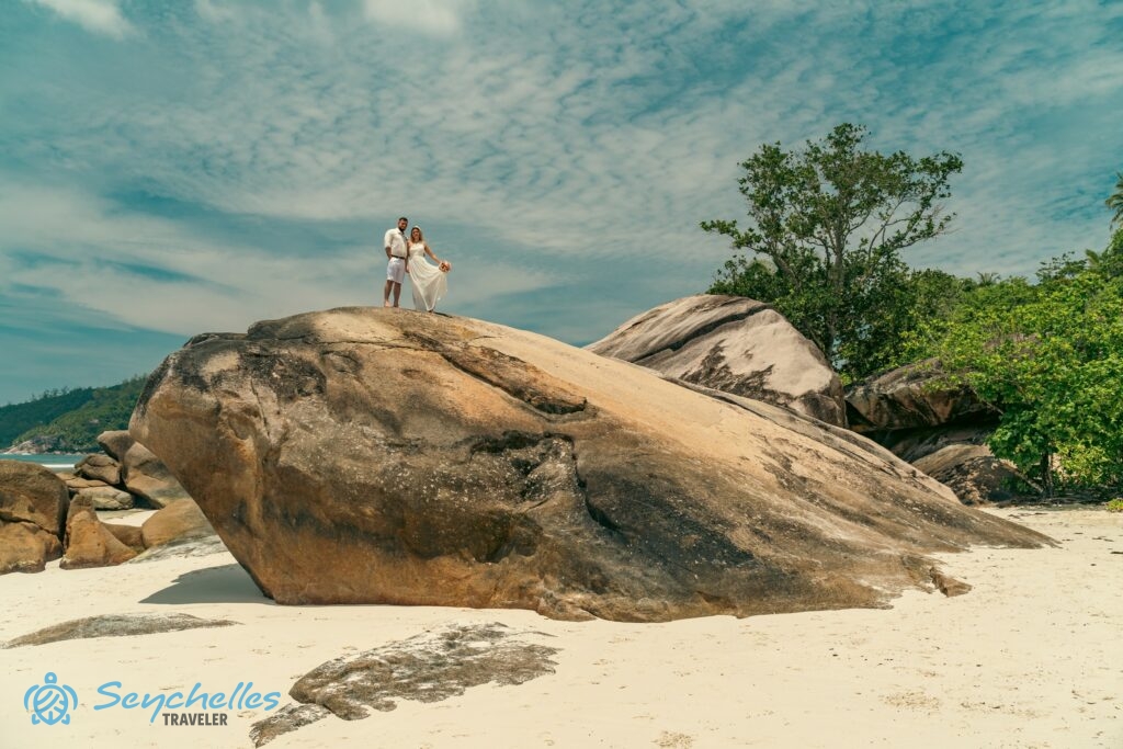 Mahén, Baie Lazare tengerparton egy hatalmas gránitszikla tetején állnak a friss házasok.